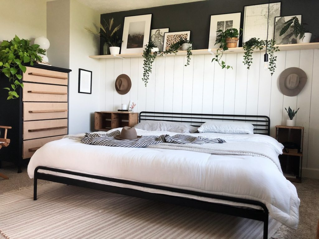 master bedroom open shelving decorate with plants and framed art
